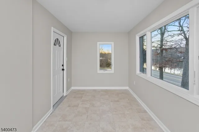a view of an empty room with windows and a balcony