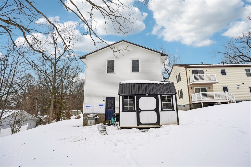 14 Balder Road Worcester, MA 01605 - Photo 32 of 34 a view of a white house with a yard covered in snow