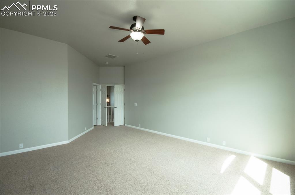 9443 St.George Road Peyton, CO 80831 - Photo 25 of 45 an empty room with a ceiling fan and a window