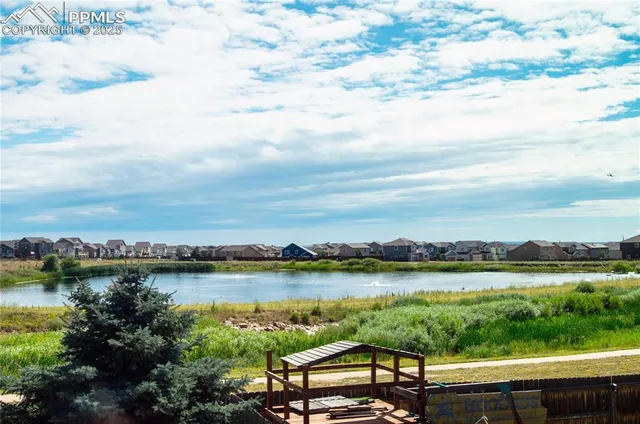 a view of a lake with houses in the back