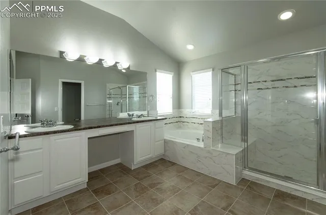 a bathroom with a double vanity sink and a mirror