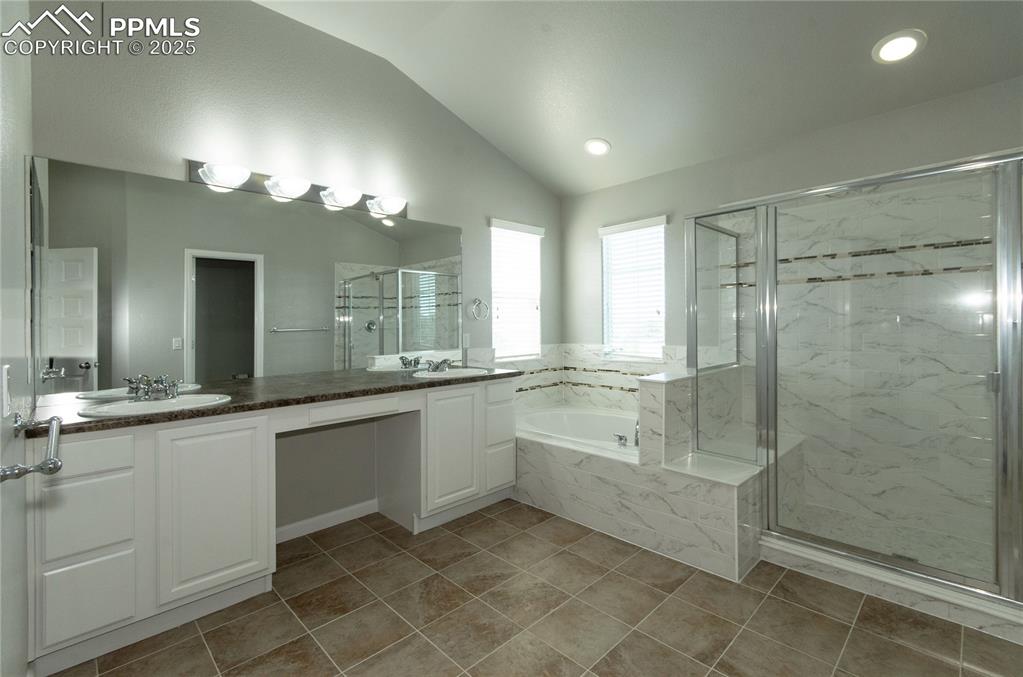 9443 St.George Road Peyton, CO 80831 - Photo 29 of 45 a bathroom with a double vanity sink and a mirror