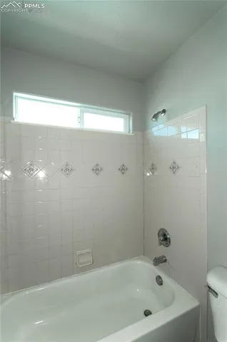 a bathroom with a bathtub and shower