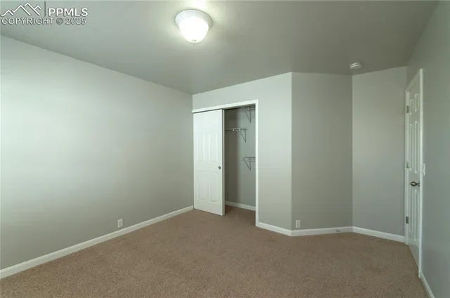 an empty room with closet area