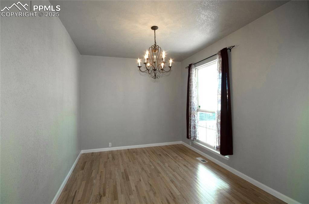 9443 St.George Road Peyton, CO 80831 - Photo 5 of 45 wooden floor in an empty room with a window