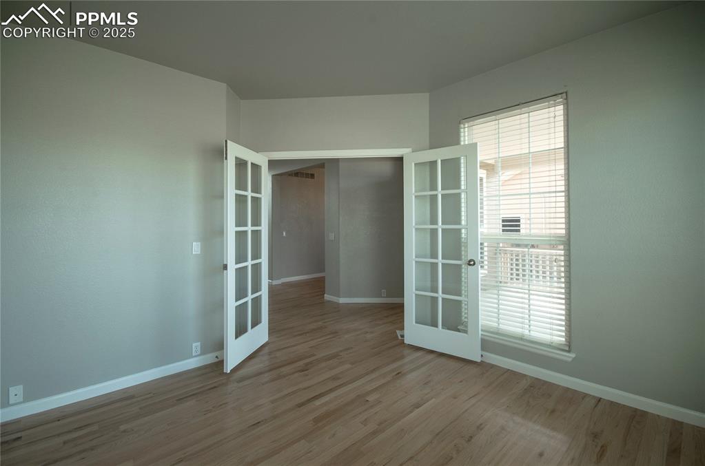 9443 St.George Road Peyton, CO 80831 - Photo 7 of 45 an empty room with wooden floor and windows