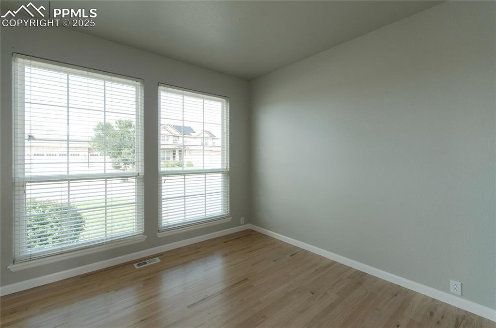 9443 St.George Road Peyton, CO 80831 - Photo 8 of 45 a view of an empty room with wooden floor and a window
