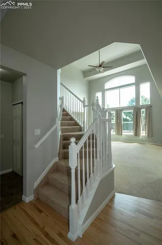 a view of staircase with wooden floor and windows