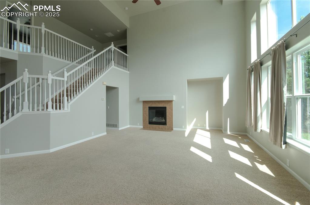 9443 St.George Road Peyton, CO 80831 - Photo 10 of 45 a view of an empty room with a fireplace and windows