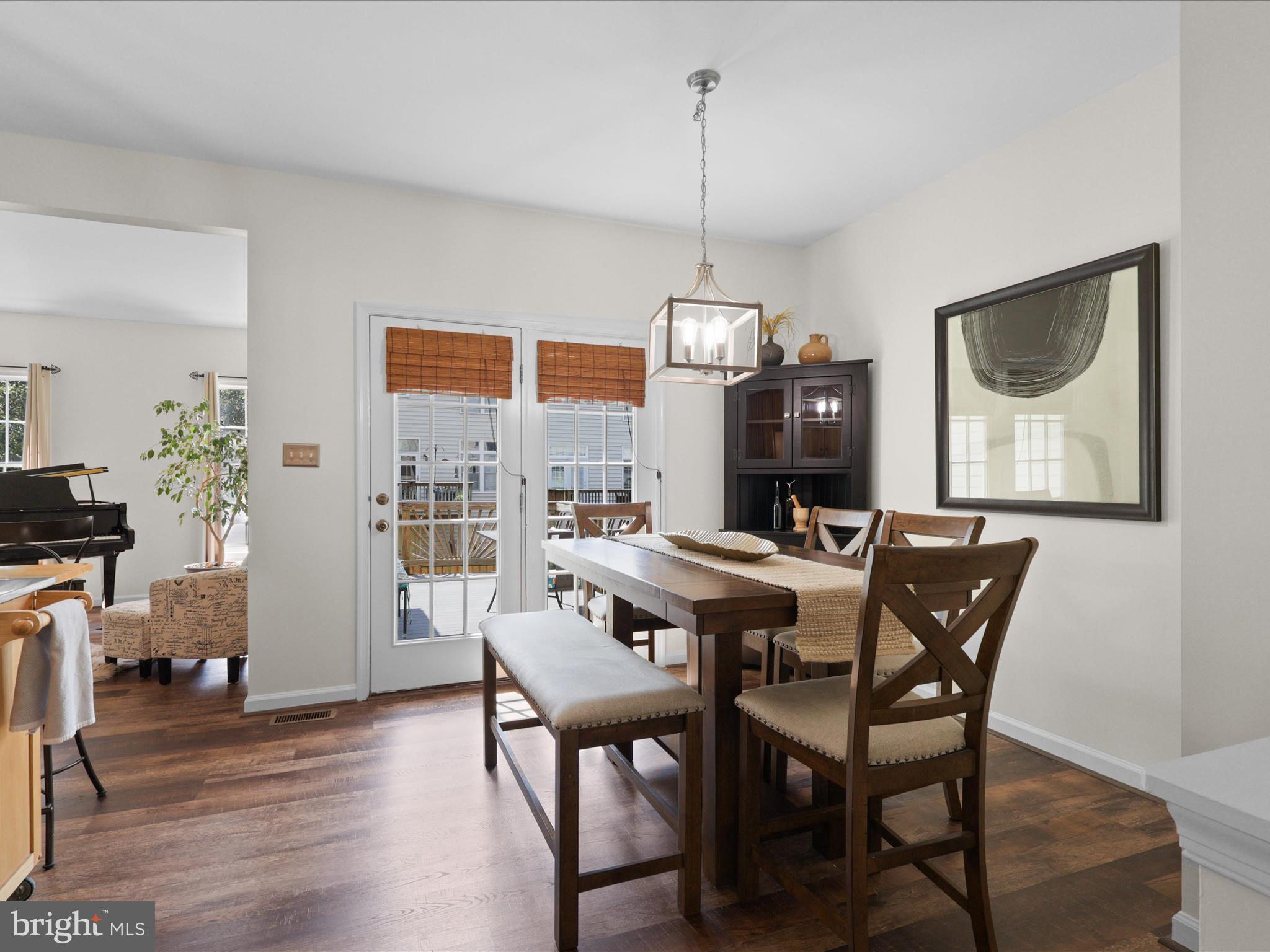 25449 Morse Drive Chantilly, VA 20152 - Photo 6 of 46 a view of a dining room with furniture wooden floor and a chandelier