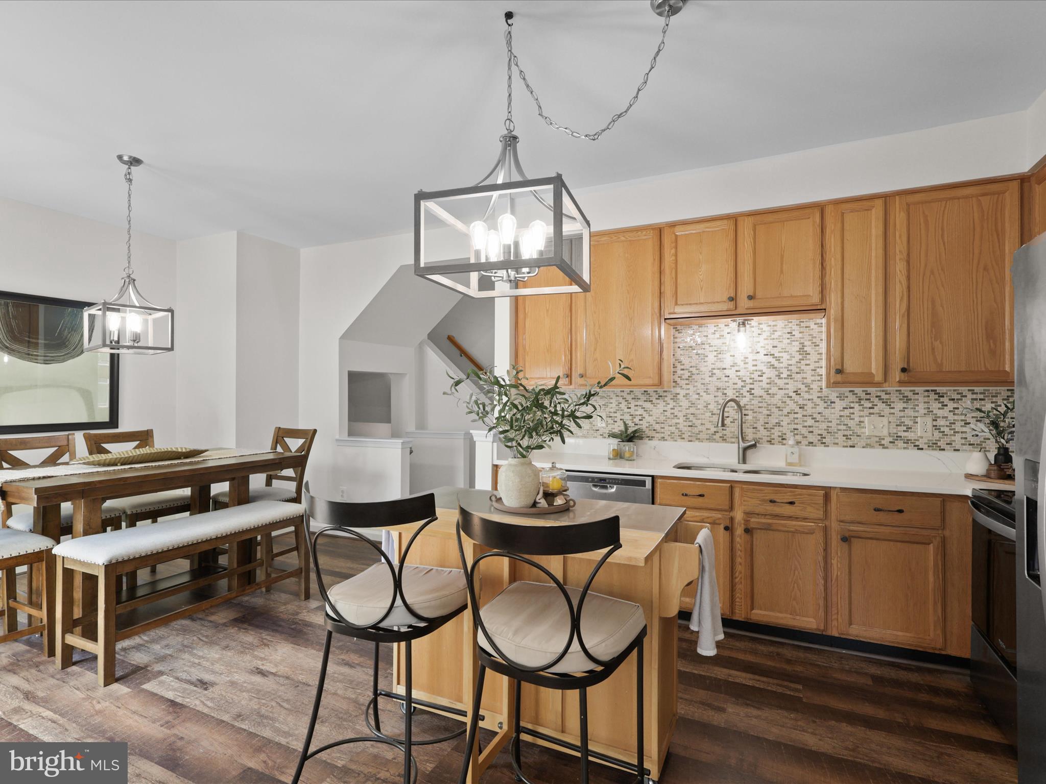 25449 Morse Drive Chantilly, VA 20152 - Photo 10 of 46 a kitchen with stainless steel appliances a stove a sink and cabinets