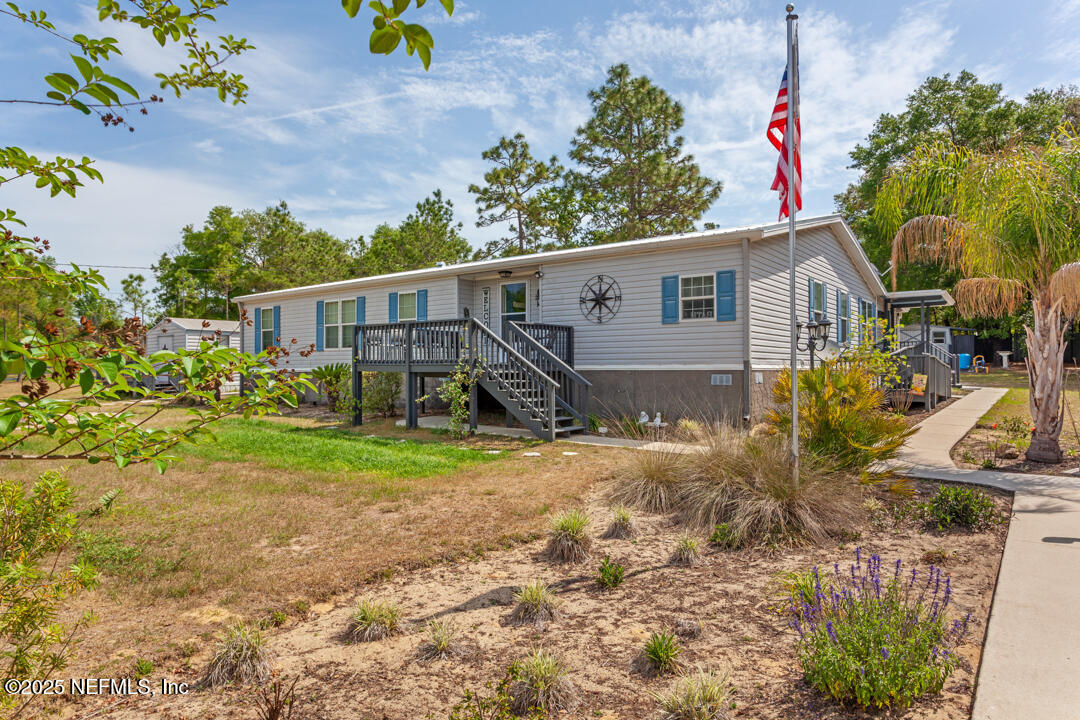 a view of a house with wooden fence