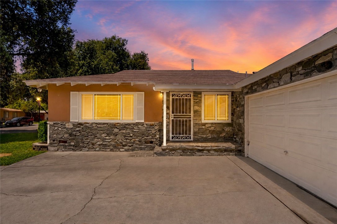 4869 Serrano Place Riverside, CA 92504 - Photo 2 of 40 Inviting front entry with attractive stone accents, a large garage, and a cozy covered approach to the home.