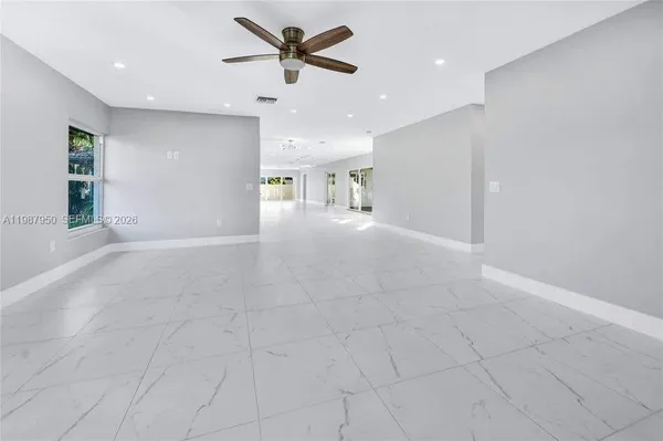a view of a livingroom with a ceiling fan and window