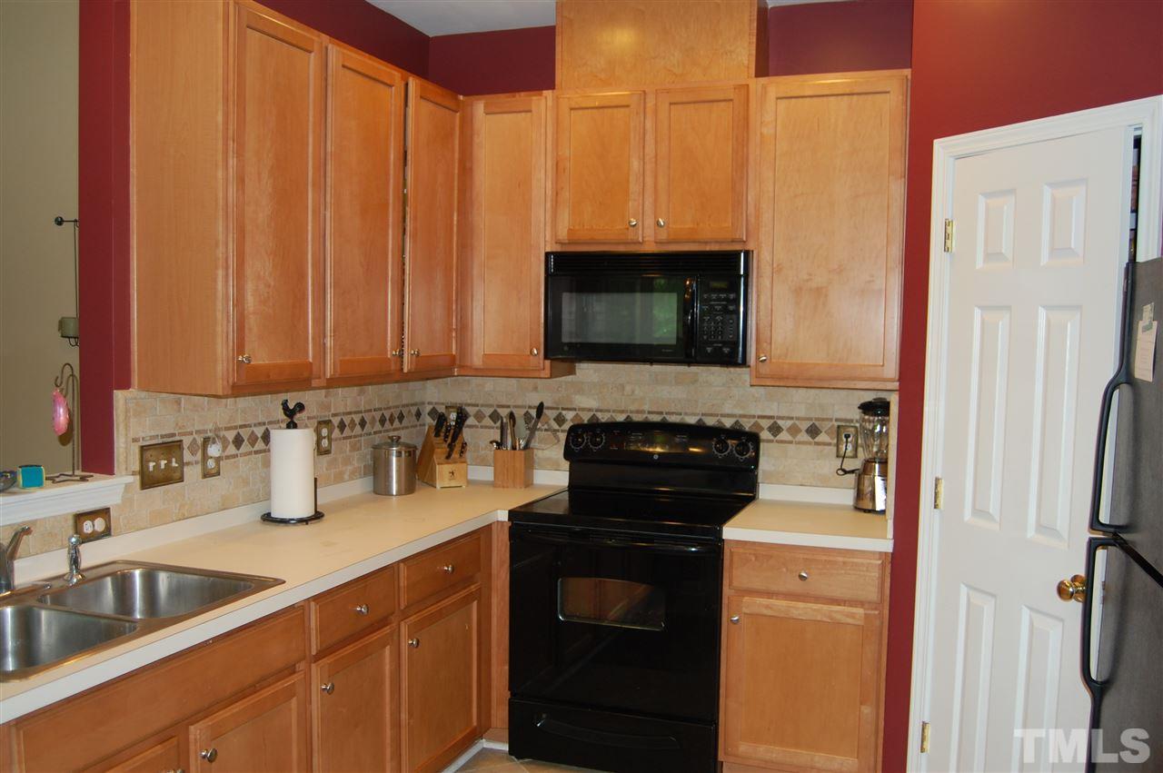 2629 Dality Drive Raleigh, NC 27604 - Photo 8 of 16 a kitchen with stainless steel appliances granite countertop a sink stove and refrigerator