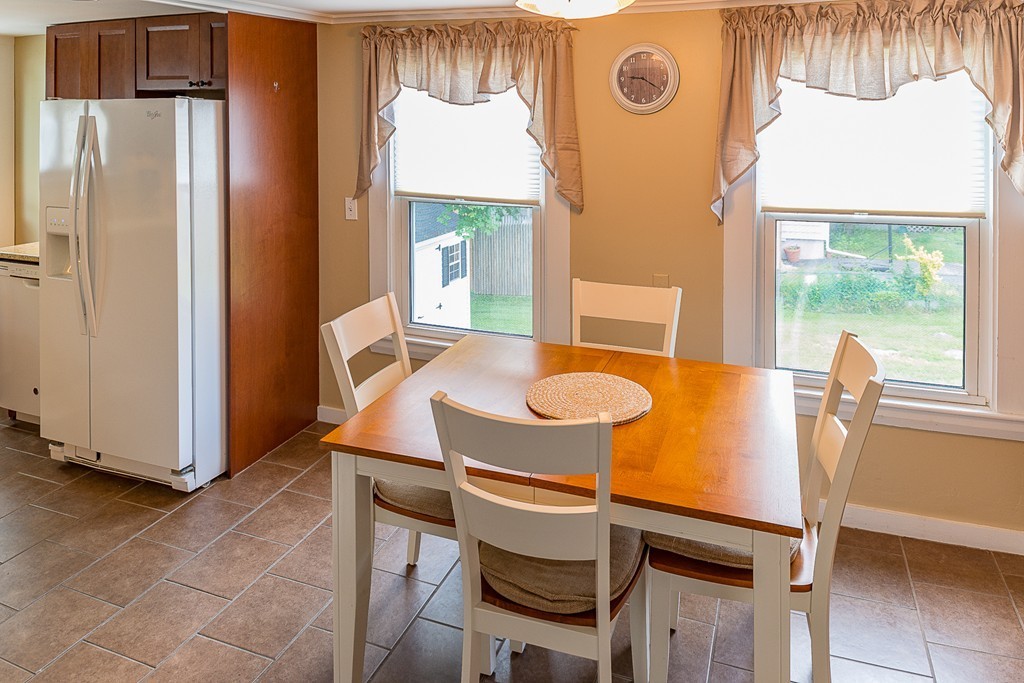 32 Bayview Road Marblehead, MA 01945 - Photo 4 of 12 a dining room with a table chairs and a refrigerator