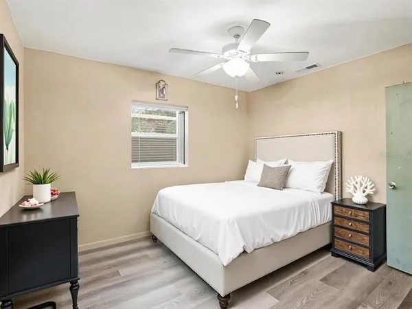 a bedroom with a bed and a chandelier
