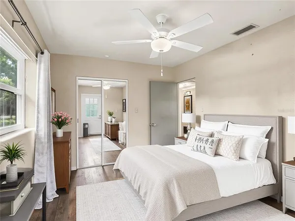 a bedroom with a large bed and a chandelier
