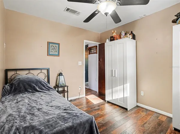 a bedroom with a bed and a large mirror
