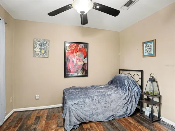a bedroom with furniture and wooden floor