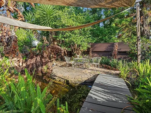 a view of a backyard with sitting area