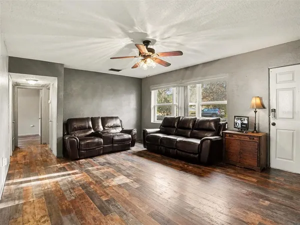 a living room with furniture and a chandelier