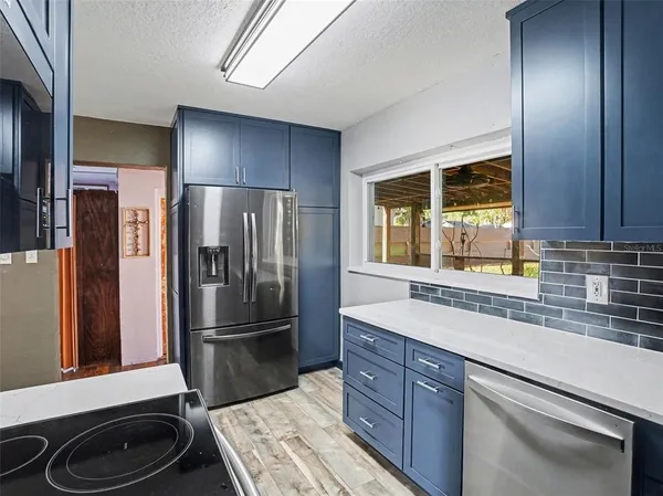a kitchen with a refrigerator and a sink