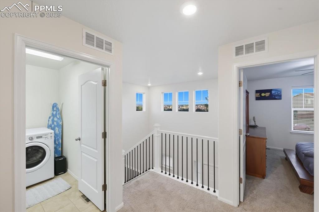 10539 Casper Point Parker, CO 80134 - Photo 20 of 35 Corridor featuring washer / dryer, an upstairs landing, recessed lighting, and light carpet