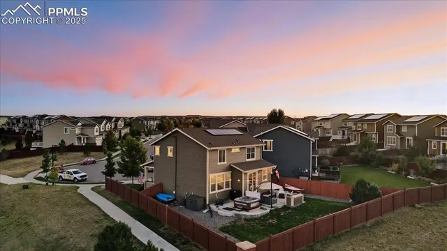 a view of a house with a yard and sitting area