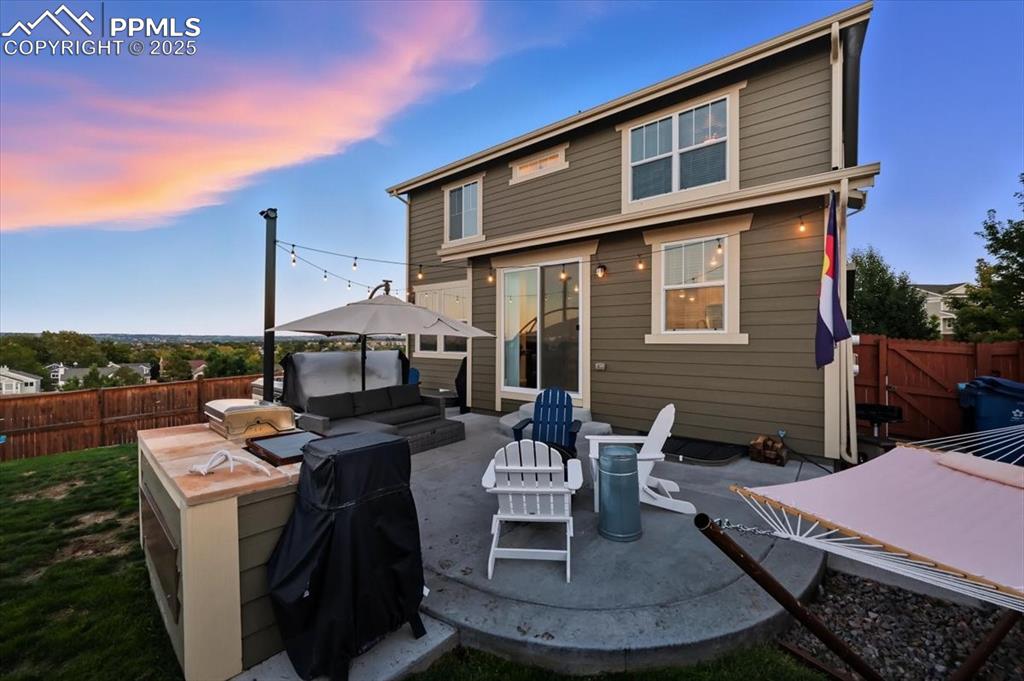 10539 Casper Point Parker, CO 80134 - Photo 21 of 35 Rear view of property with a fenced backyard, a patio area, and an outdoor hangout area