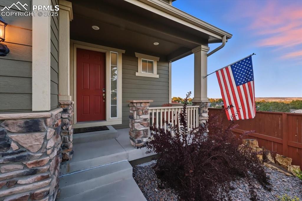 10539 Casper Point Parker, CO 80134 - Photo 3 of 35 Exterior entry at dusk featuring covered porch