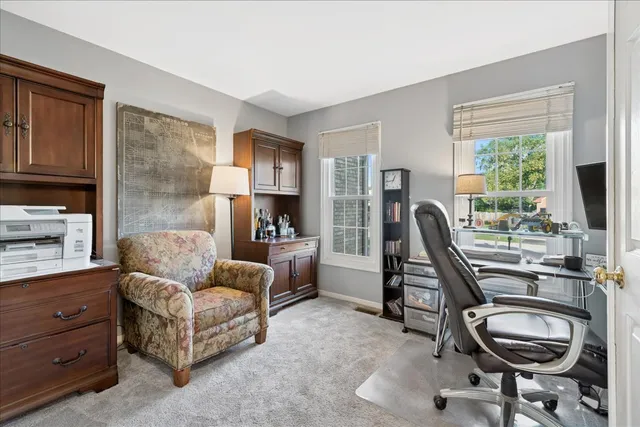 a work room with furniture and a flat screen tv