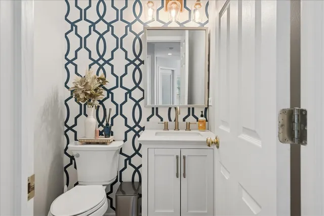a bathroom with a sink toilet and mirror