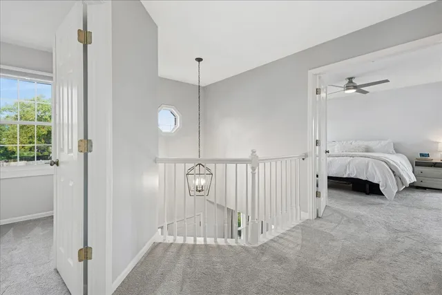 a view of a room with a large window and chandelier