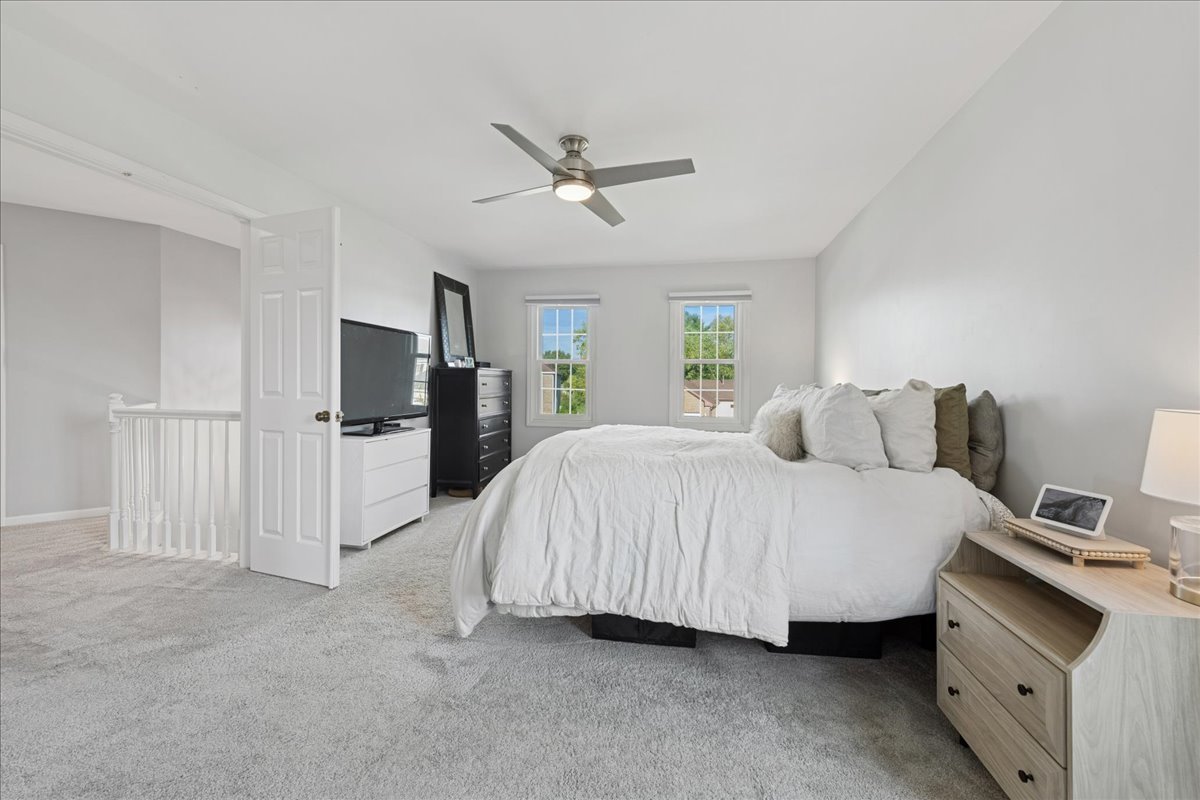 2 Daybreak Ridge Trail Cary, IL 60013 - Photo 17 of 37 a spacious bedroom with a bed and a flat screen tv