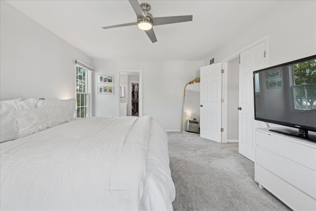 2 Daybreak Ridge Trail Cary, IL 60013 - Photo 18 of 37 a bedroom with a bed and a flat screen tv