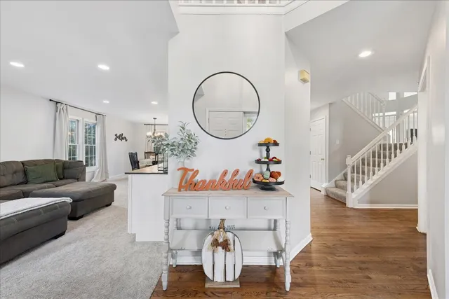 a living room with furniture a rug and kitchen view