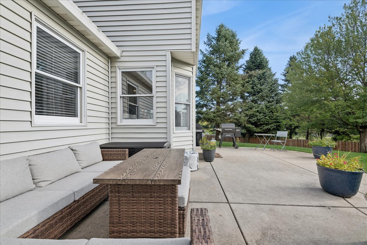 2 Daybreak Ridge Trail Cary, IL 60013 - Photo 25 of 37 a view of a patio with a table and chairs and potted plants