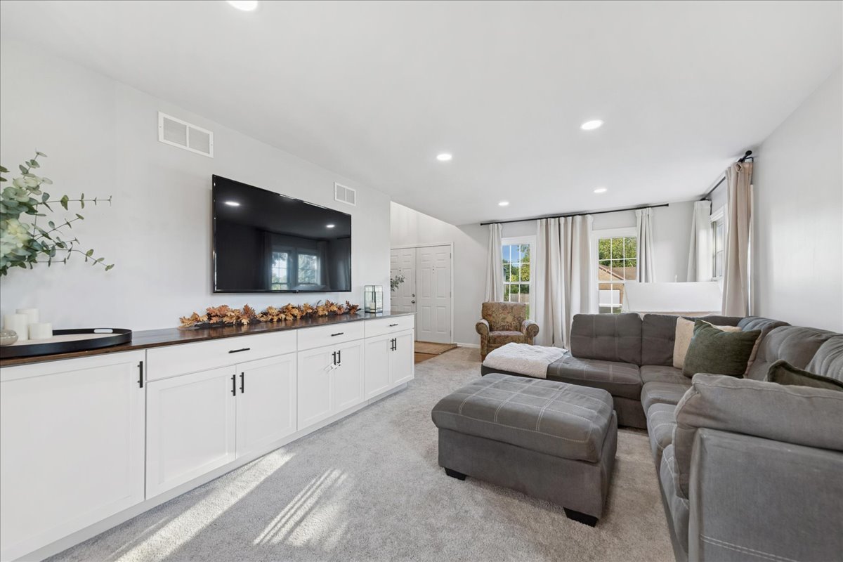 2 Daybreak Ridge Trail Cary, IL 60013 - Photo 3 of 37 a living room with furniture and a flat screen tv