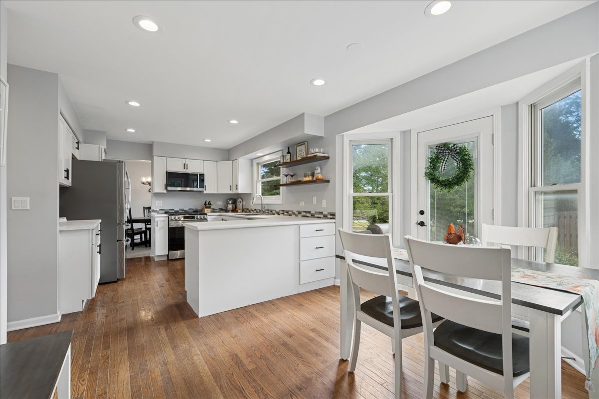 2 Daybreak Ridge Trail Cary, IL 60013 - Photo 6 of 37 a kitchen with white cabinets and stainless steel appliances