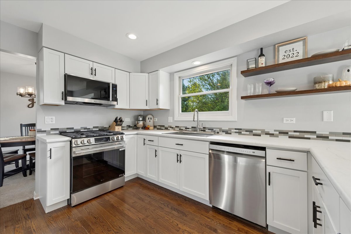 2 Daybreak Ridge Trail Cary, IL 60013 - Photo 8 of 37 a kitchen with cabinets stainless steel appliances a sink and a stove