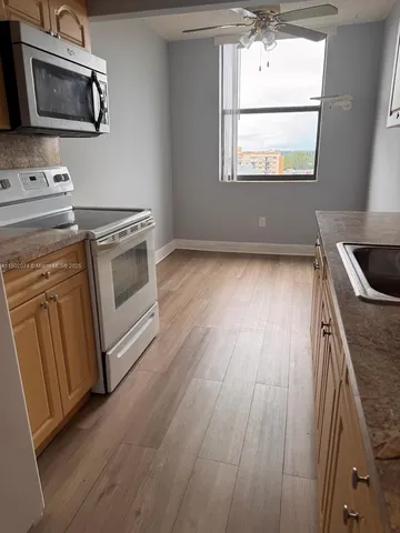 a kitchen with wooden floors and a sink