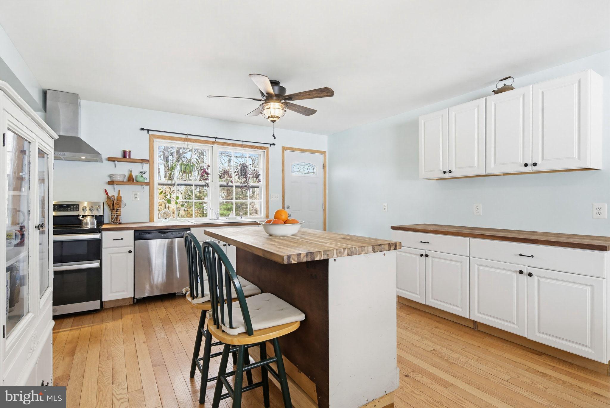 2124 Oaklyn Drive Fallston, MD 21047 - Photo 7 of 33 a kitchen with stainless steel appliances granite countertop a stove a sink dishwasher and a refrigerator with wooden floor