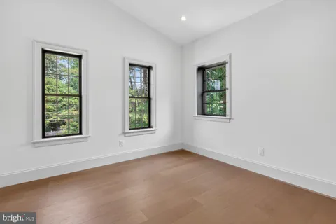a view of dining room and livingroom with furniture wooden floor a rug and a chandelier