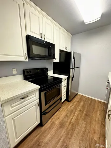 a kitchen with stainless steel appliances a stove microwave and refrigerator