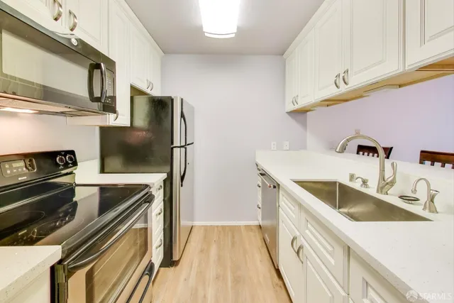 a kitchen with a sink stove and refrigerator