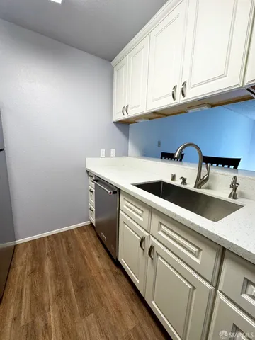 a view of a kitchen with sink and cabinets