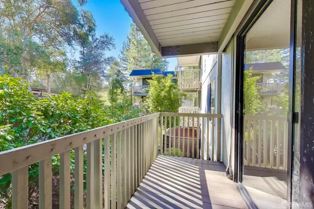a view of a balcony with wooden floor