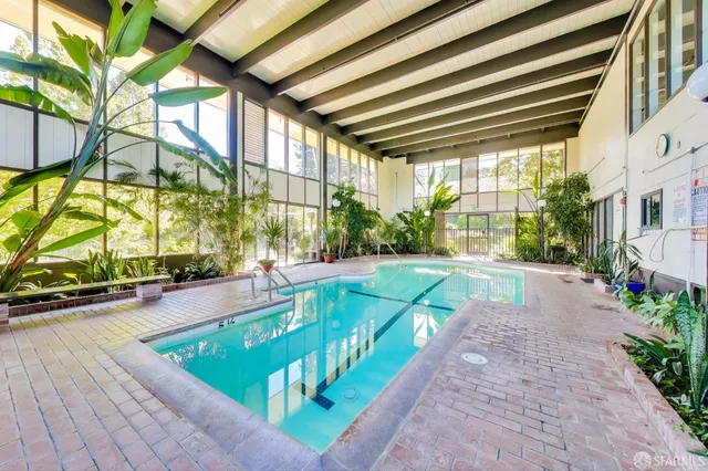 a view of a tennis court with chairs