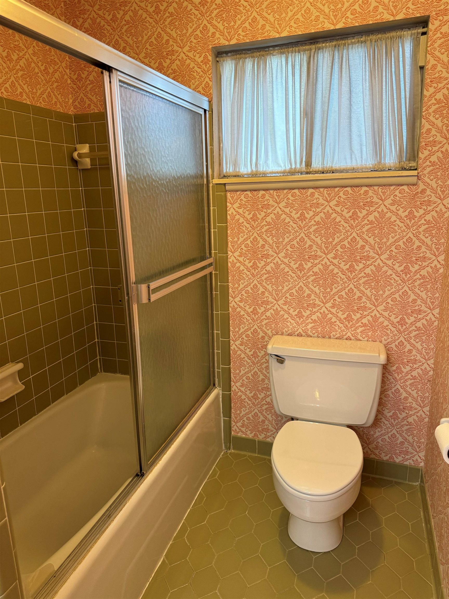6738 River Birch Road Memphis, TN 38119 - Photo 12 of 17 Bathroom with toilet, tile patterned floors, and bath / shower combo with glass door